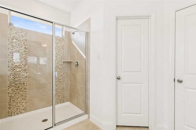 bathroom with tile patterned floors and walk in shower