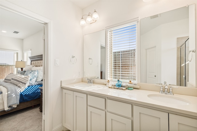 bathroom with vanity and a shower with shower door