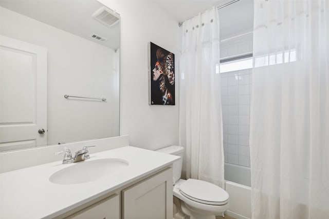 full bathroom with vanity, shower / bath combo, and toilet