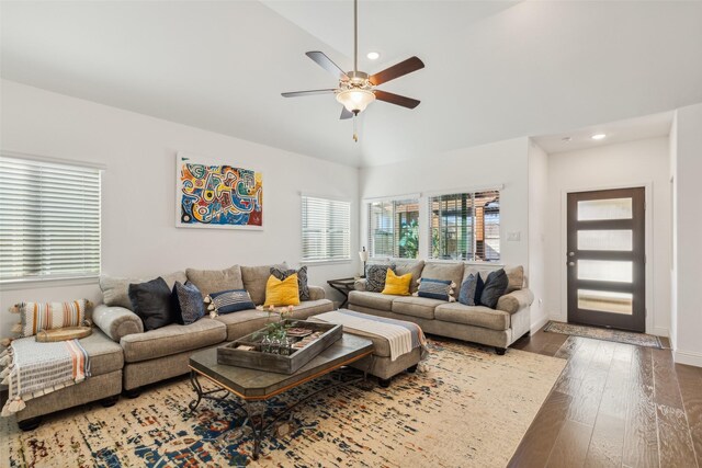 living room featuring ceiling fan, dark hardwood / wood-style flooring, and vaulted ceiling