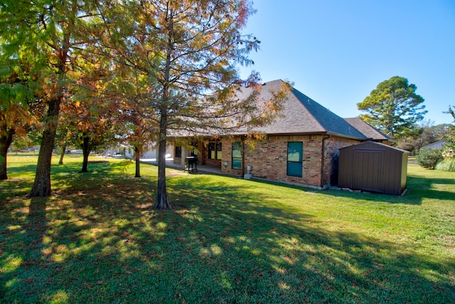 exterior space featuring a front lawn and a storage unit