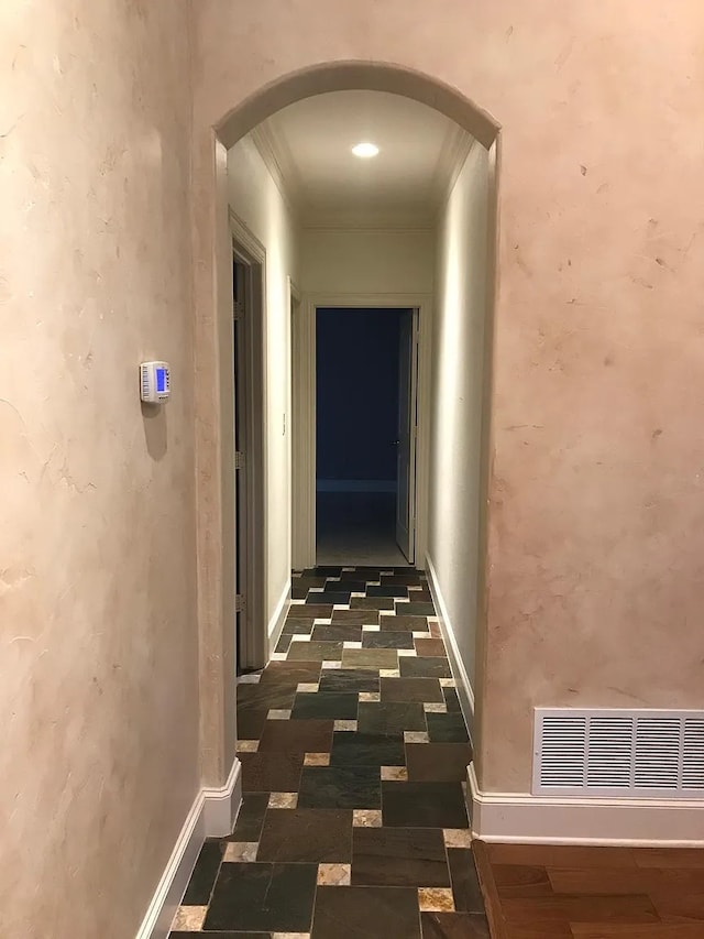 corridor featuring crown molding