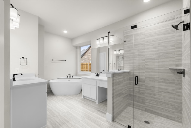 bathroom with shower with separate bathtub and vanity