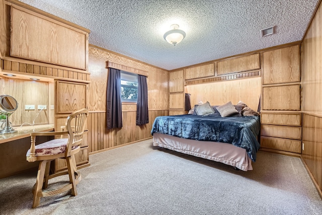 carpeted bedroom featuring ornamental molding, a textured ceiling, and wooden walls