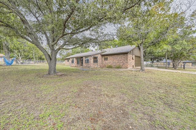 view of front of house with a front yard and a garage