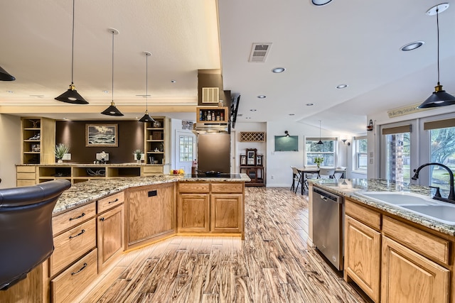 kitchen featuring sink, dishwasher, decorative light fixtures, and light wood-type flooring