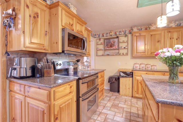 kitchen featuring pendant lighting, light brown cabinets, and appliances with stainless steel finishes