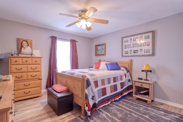 bedroom with ceiling fan and hardwood / wood-style flooring