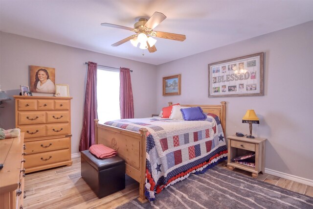 bedroom with ceiling fan and hardwood / wood-style flooring