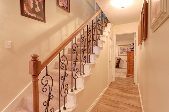 stairs with hardwood / wood-style flooring