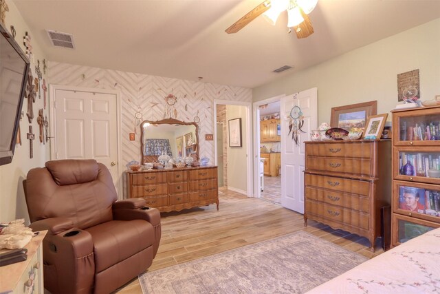 living area featuring ceiling fan and light hardwood / wood-style flooring