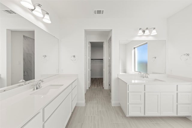 bathroom with vanity and a shower with door