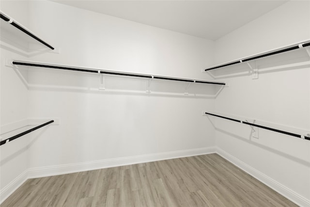 spacious closet with light hardwood / wood-style floors