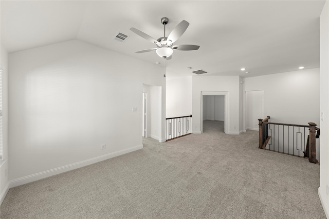 carpeted spare room featuring lofted ceiling