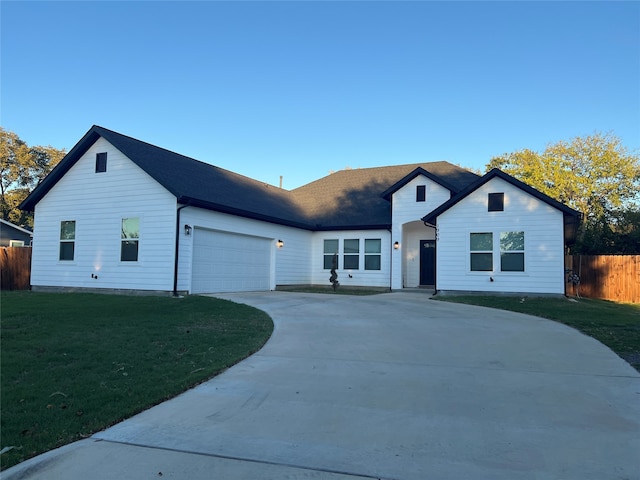 view of front of house with a front yard and a garage