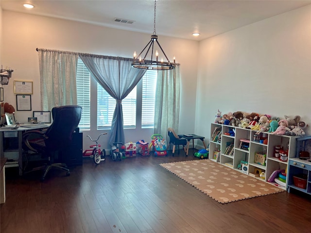 rec room featuring dark hardwood / wood-style flooring and a chandelier