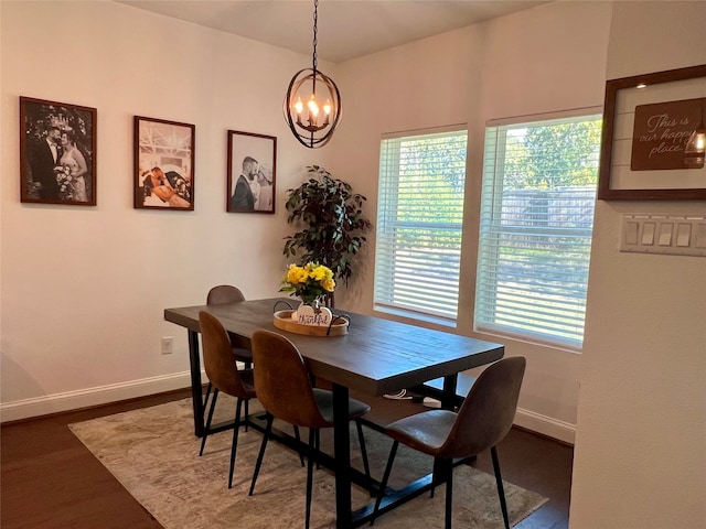 dining space with a chandelier and dark wood-type flooring