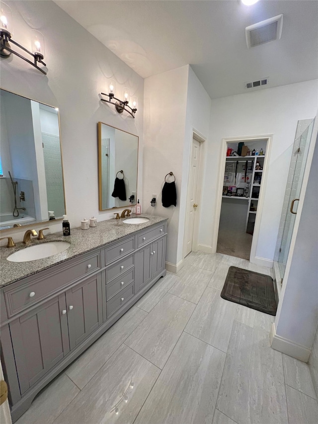 bathroom with hardwood / wood-style floors, vanity, and a shower with door