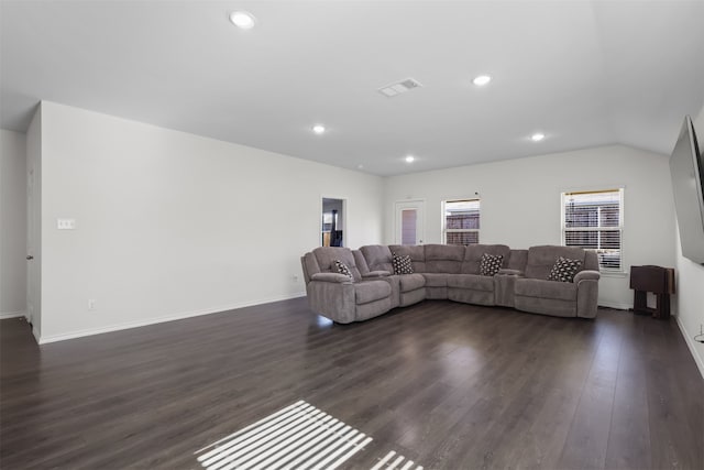 living room with dark hardwood / wood-style flooring and vaulted ceiling