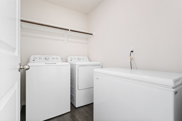 laundry room featuring washer and clothes dryer and dark hardwood / wood-style flooring