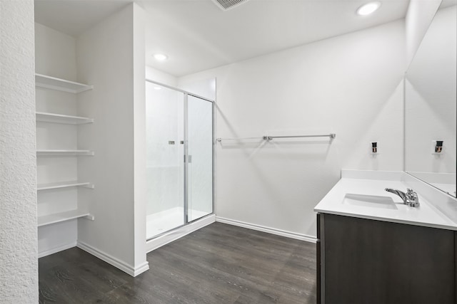 bathroom with vanity, an enclosed shower, and wood-type flooring