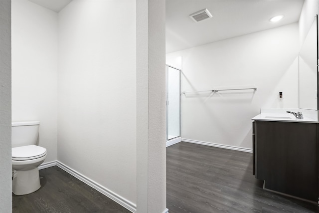 bathroom featuring wood-type flooring, vanity, and toilet