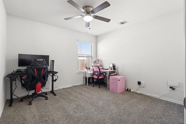 carpeted office space featuring ceiling fan