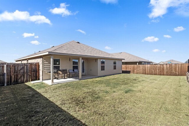 back of property featuring a yard and a patio area