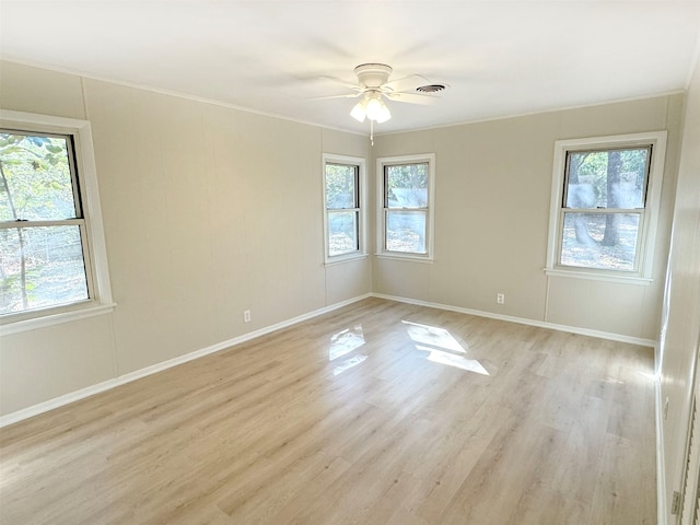 empty room with light hardwood / wood-style floors, ceiling fan, and ornamental molding