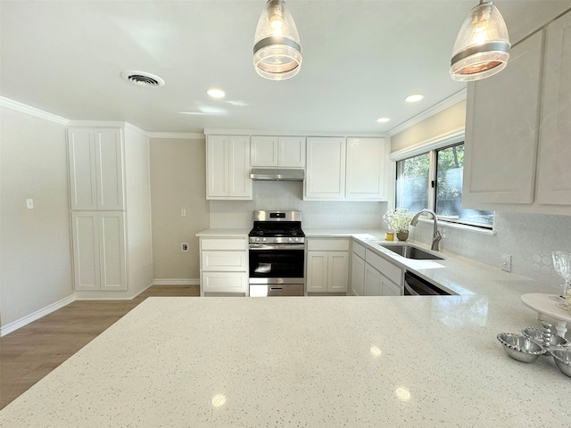 kitchen featuring stainless steel appliances, crown molding, sink, decorative light fixtures, and white cabinetry