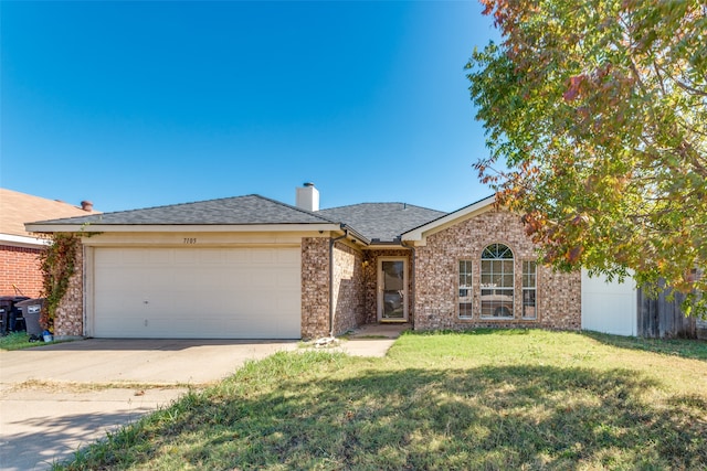 ranch-style house with a garage and a front lawn