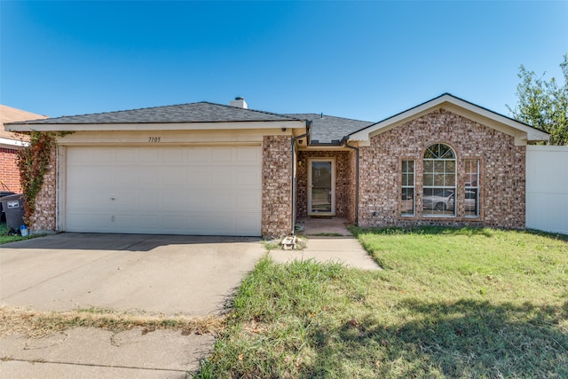 ranch-style house featuring a front lawn and a garage