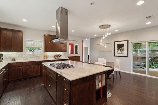 kitchen featuring a center island, hanging light fixtures, island exhaust hood, decorative backsplash, and appliances with stainless steel finishes