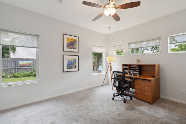 home office with light carpet and ceiling fan