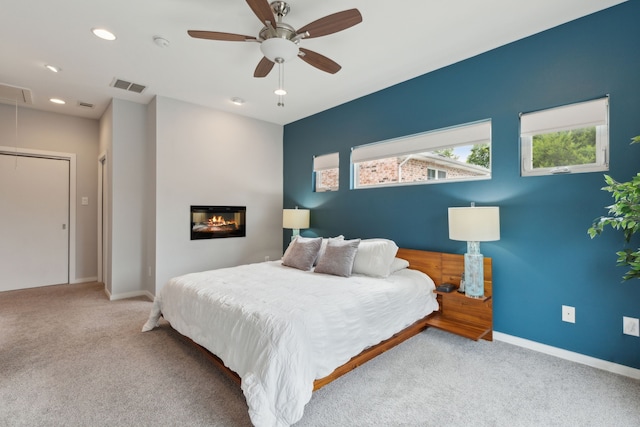 bedroom featuring ceiling fan and light colored carpet