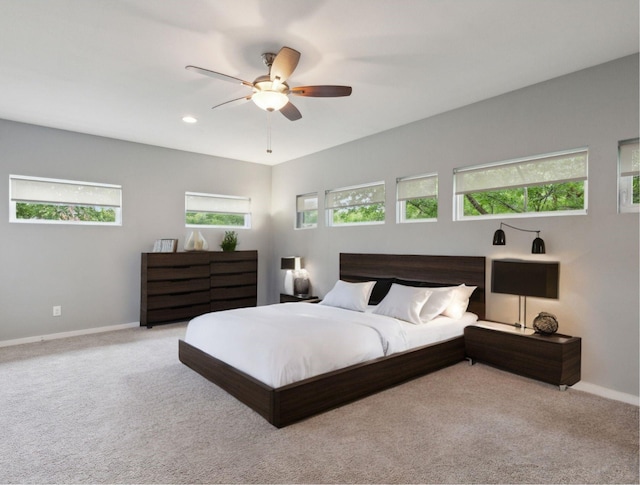 bedroom with ceiling fan and light carpet