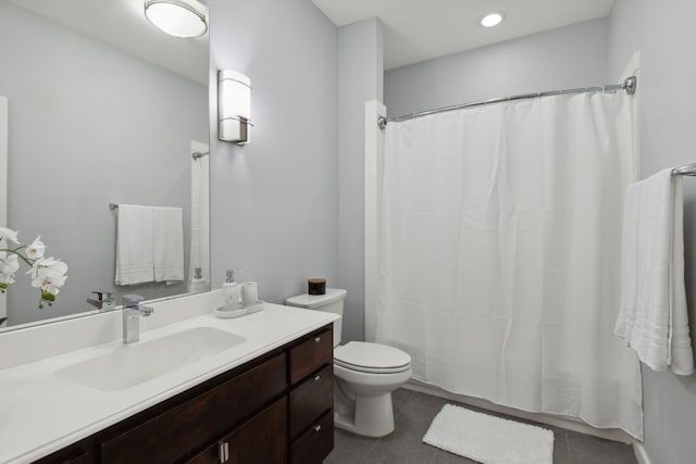 bathroom featuring toilet, vanity, and tile patterned floors