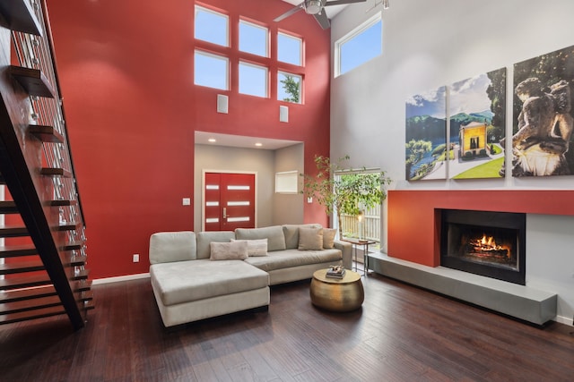 living room with hardwood / wood-style floors and ceiling fan