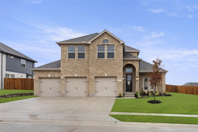 view of front of home featuring a front yard and a garage