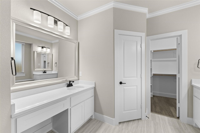 bathroom featuring hardwood / wood-style floors, vanity, and ornamental molding