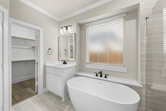 bathroom featuring hardwood / wood-style floors, vanity, a bath, and ornamental molding