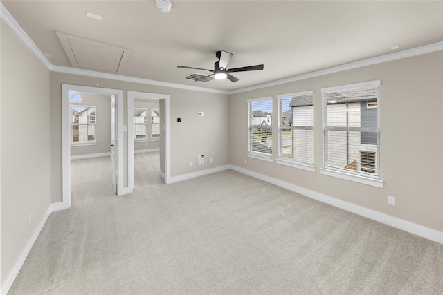 unfurnished room featuring ceiling fan, crown molding, and light carpet