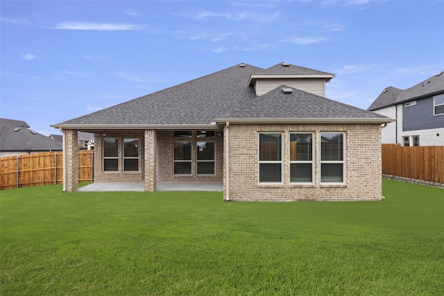 back of property featuring a yard and a patio area