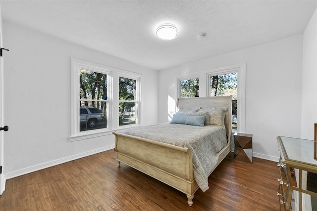 bedroom featuring dark wood-type flooring and a textured ceiling