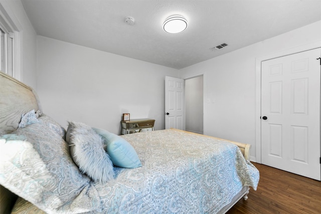 bedroom with dark hardwood / wood-style flooring