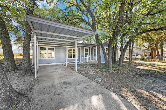 view of front of property featuring a carport and a porch