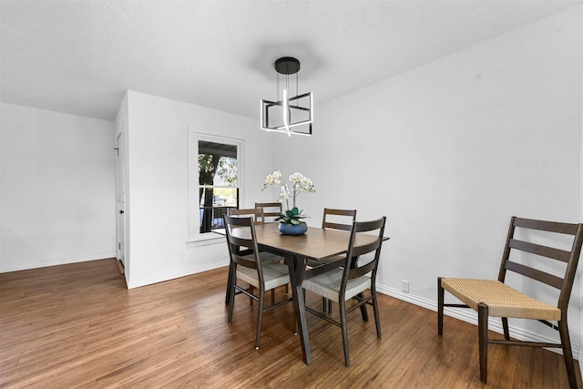 4536 Hodgkins Rd, Lake Worth, TX 76135 - dining area featuring wood finished floors, baseboards, and a chandelier