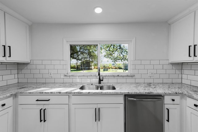 4536 Hodgkins Rd, Lake Worth, TX 76135 - kitchen featuring stainless steel dishwasher, a sink, white cabinetry, and backsplash