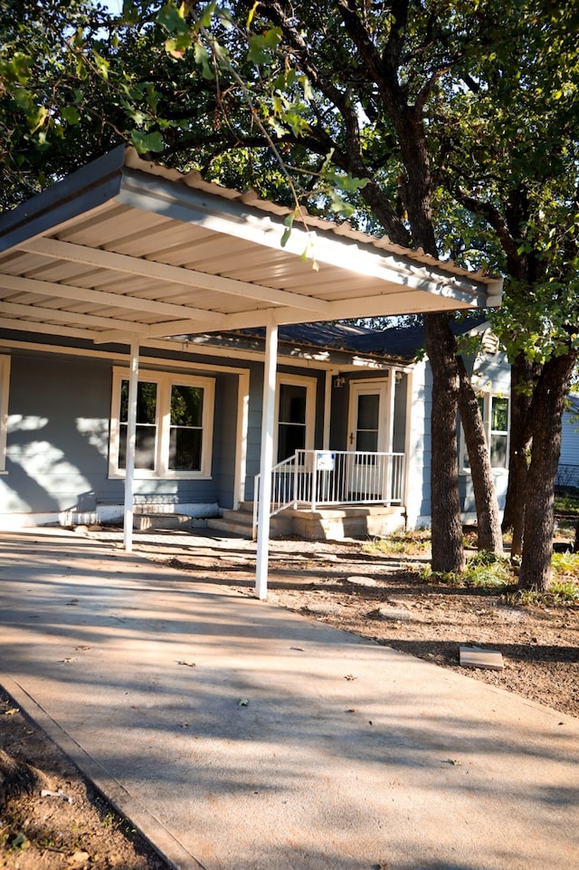 view of front of property with covered porch and a carport