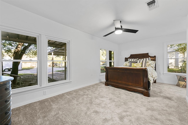 bedroom featuring carpet, multiple windows, and ceiling fan